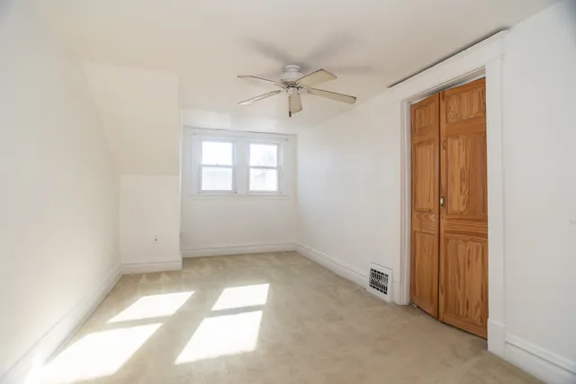 an empty room with windows and closet