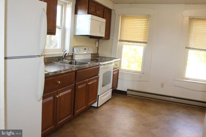 5056 East Berlin Road Thomasville, PA 17364 - Photo 2 of 4 a kitchen with a sink cabinets appliances and a window