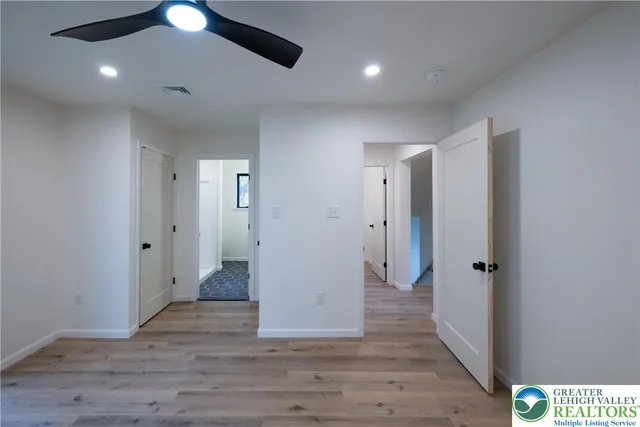 a view of a hallway with wooden floor