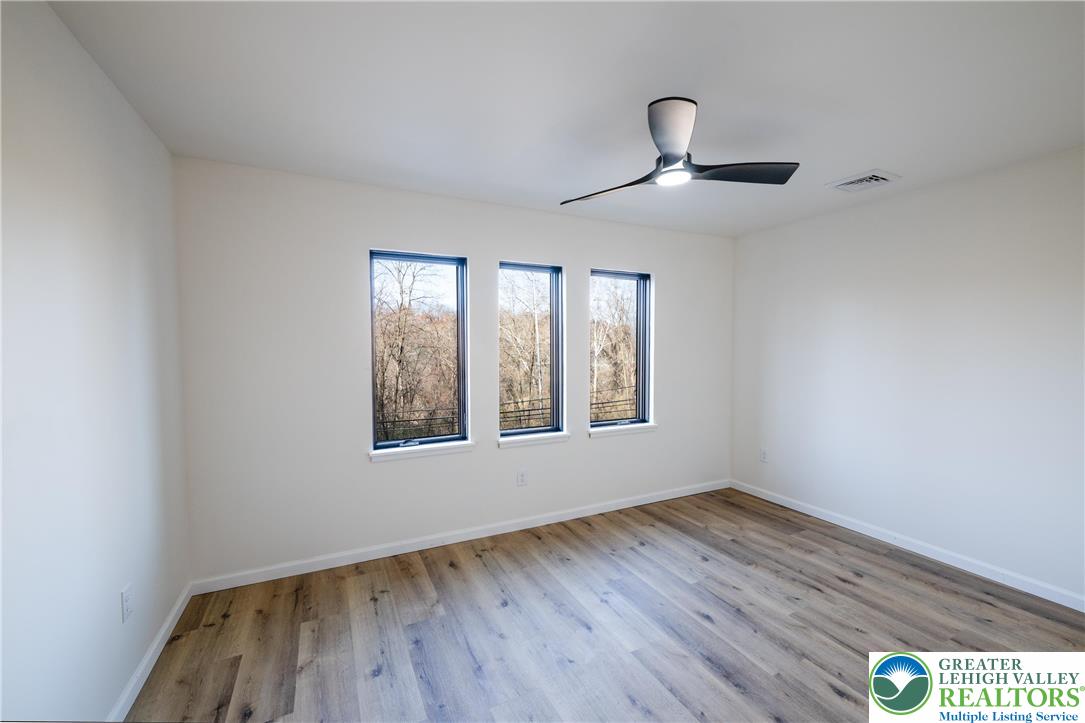 111 Main Street Glendon, PA 18042 - Photo 18 of 33 a view of an empty room with wooden floor and a window
