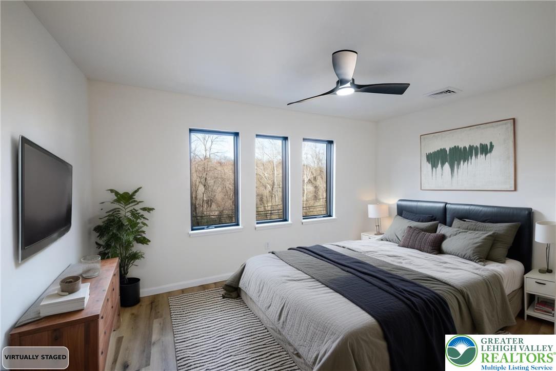 111 Main Street Glendon, PA 18042 - Photo 19 of 33 a bedroom with a large bed and a flat tv screen on a dresser