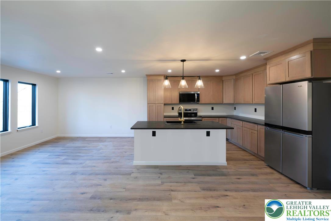 111 Main Street Glendon, PA 18042 - Photo 2 of 33 a kitchen with stainless steel appliances kitchen island a refrigerator sink and cabinets