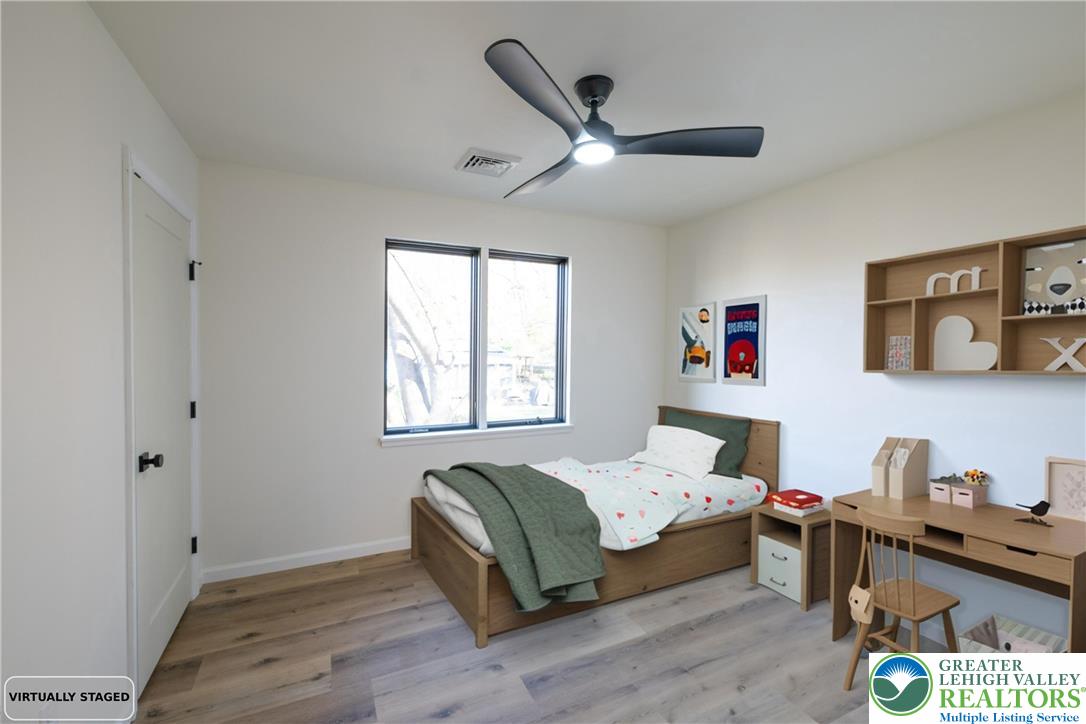 111 Main Street Glendon, PA 18042 - Photo 22 of 33 a bedroom with a bed a dresser next to a window
