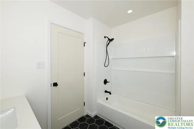 a bathroom with a bathtub and shower
