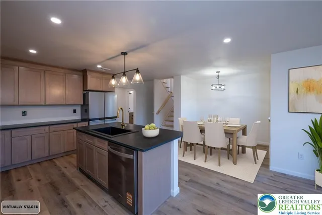 a kitchen with stainless steel appliances granite countertop a sink stove and wooden floor