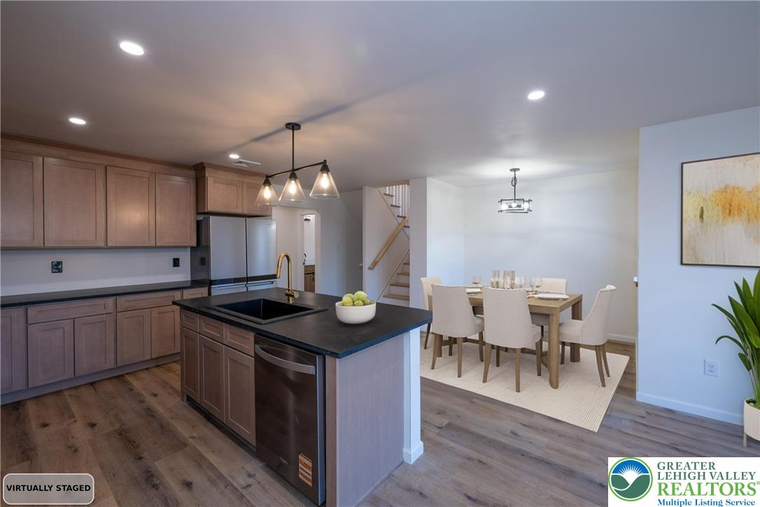 111 Main Street Glendon, PA 18042 - Photo 3 of 33 a kitchen with stainless steel appliances granite countertop a sink stove and wooden floor