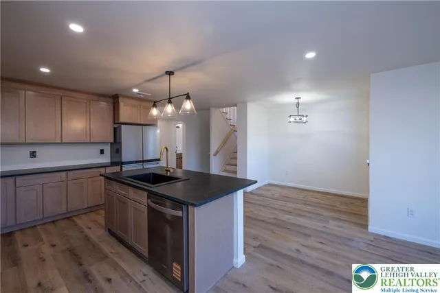 a kitchen that has a sink and a stove in it