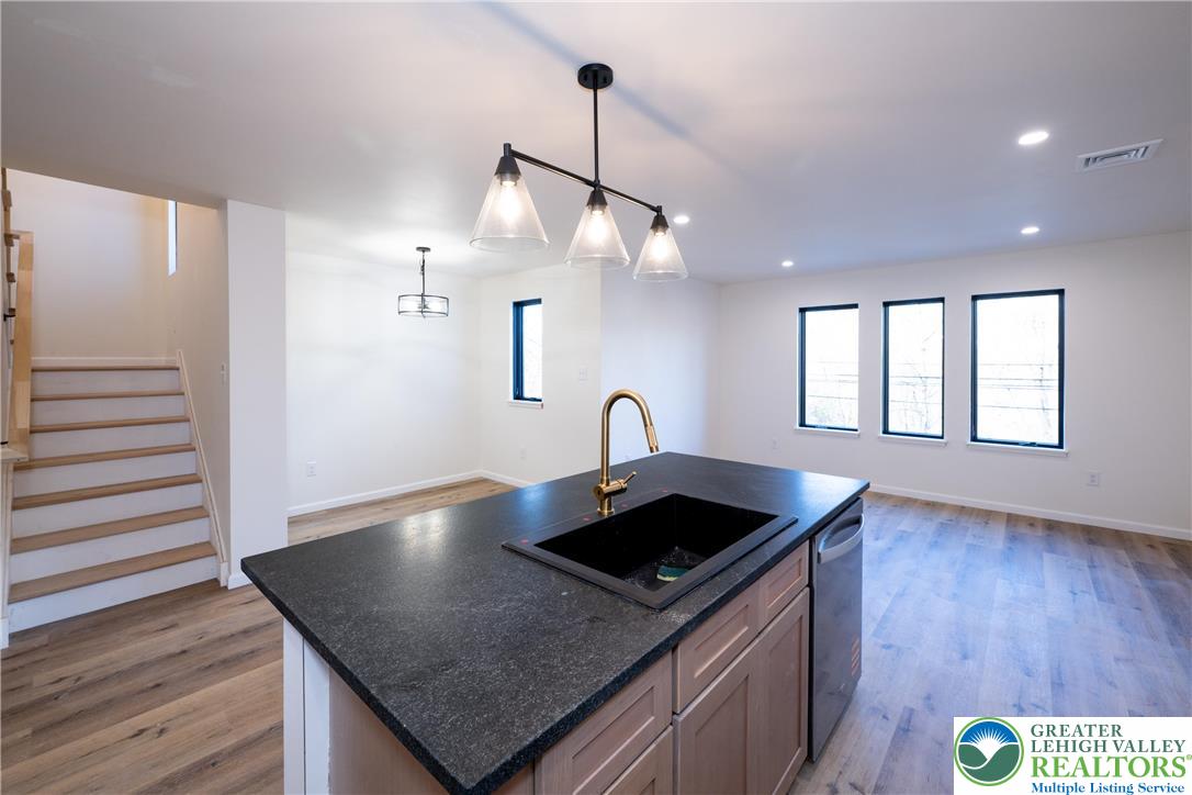 111 Main Street Glendon, PA 18042 - Photo 5 of 33 a kitchen with kitchen island a sink and wooden floor