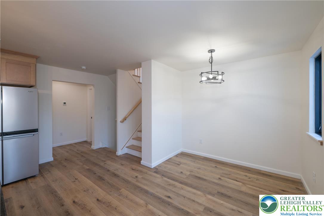 111 Main Street Glendon, PA 18042 - Photo 7 of 33 a view of empty room with wooden floor and kitchen