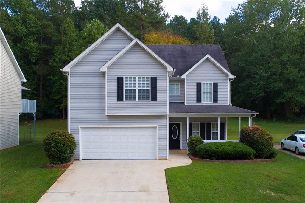 747 Crystal Bay Road Villa Rica, GA 30180 - Photo 1 of 1 a front view of a house with a yard and garage