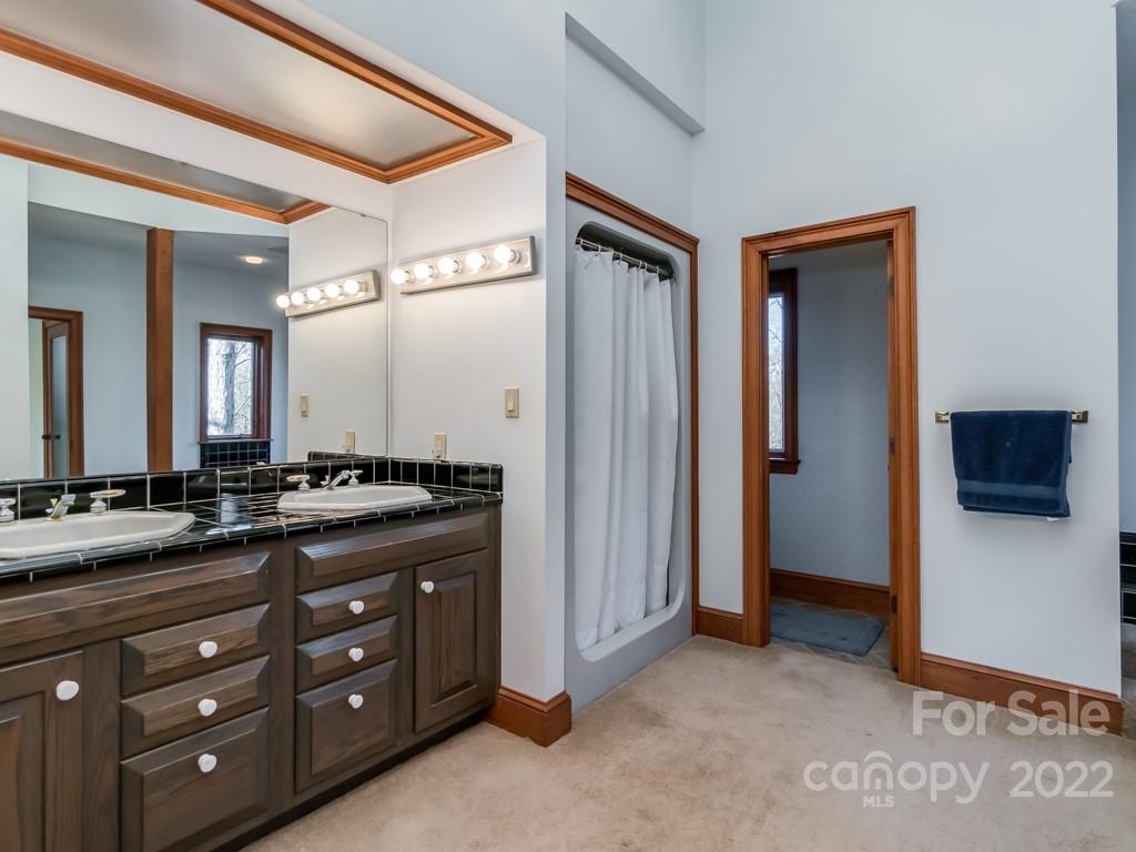 2214 Wishbone Road Monroe, NC 28112 - Photo 29 of 44 a spacious bathroom with a granite countertop sink and a mirror