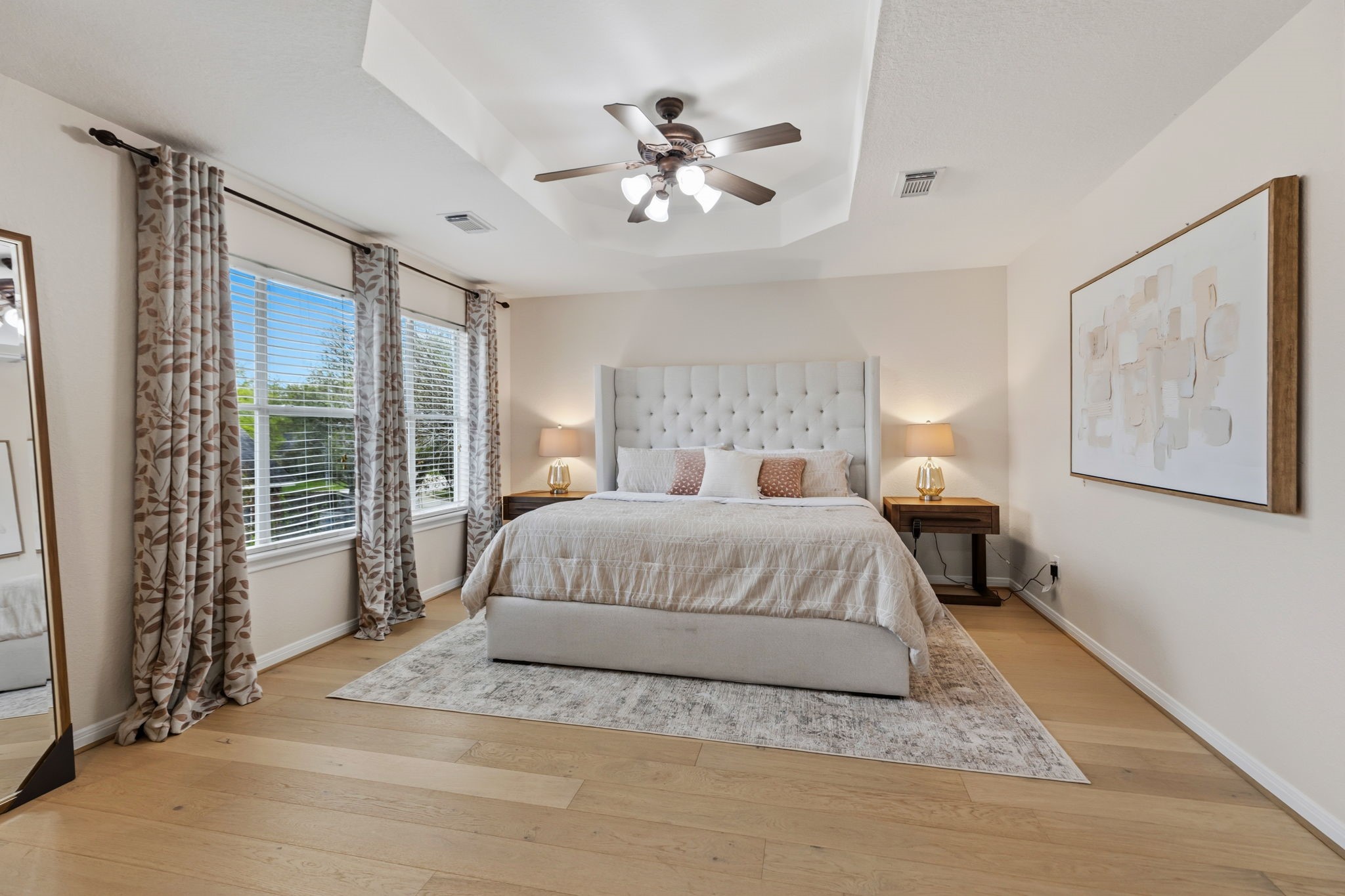 20102 Windbury Court Spring, TX 77379 - Photo 19 of 49 a bedroom with a large bed and a chandelier