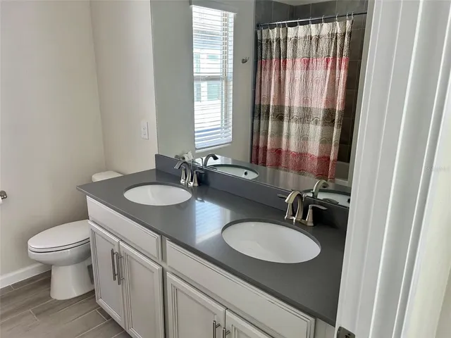 a bathroom with a sink toilet a mirror and tub