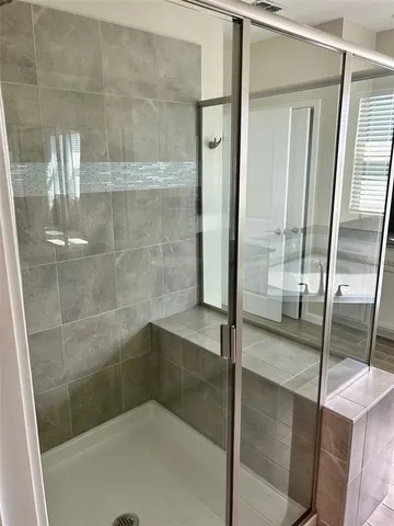 a bathroom with a glass shower door