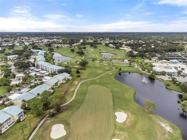 an aerial view of a residential houses with outdoor space