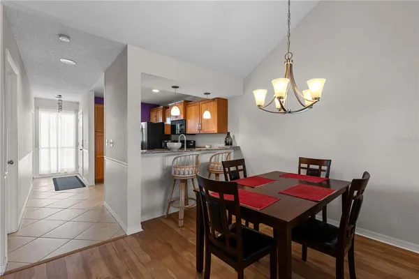 a view of a dining room with furniture and chandelier