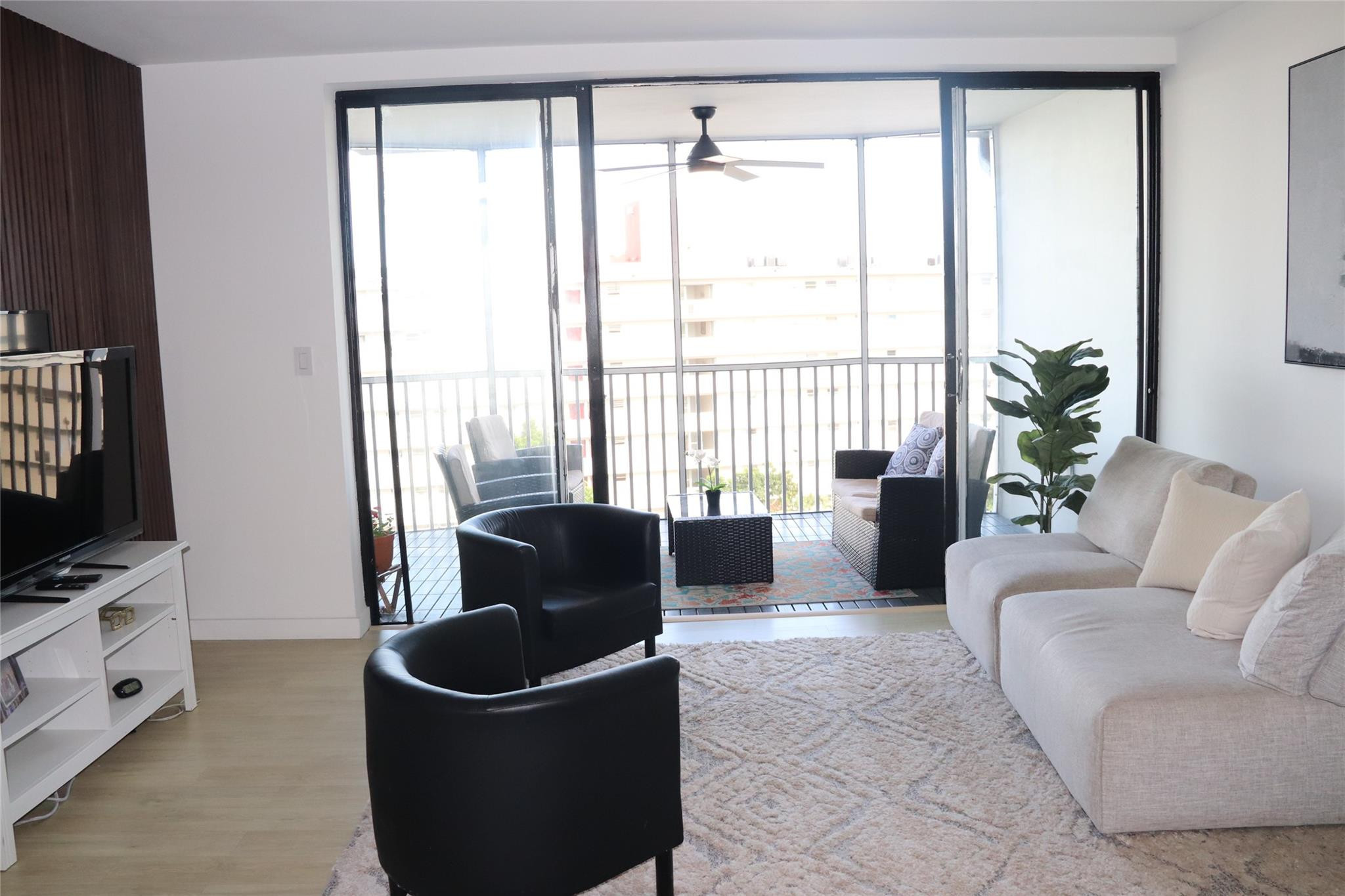 1770 Northeast 191st Street, Unit 816 Miami, FL 33179 - Photo 13 of 33 a living room with furniture and a flat screen tv