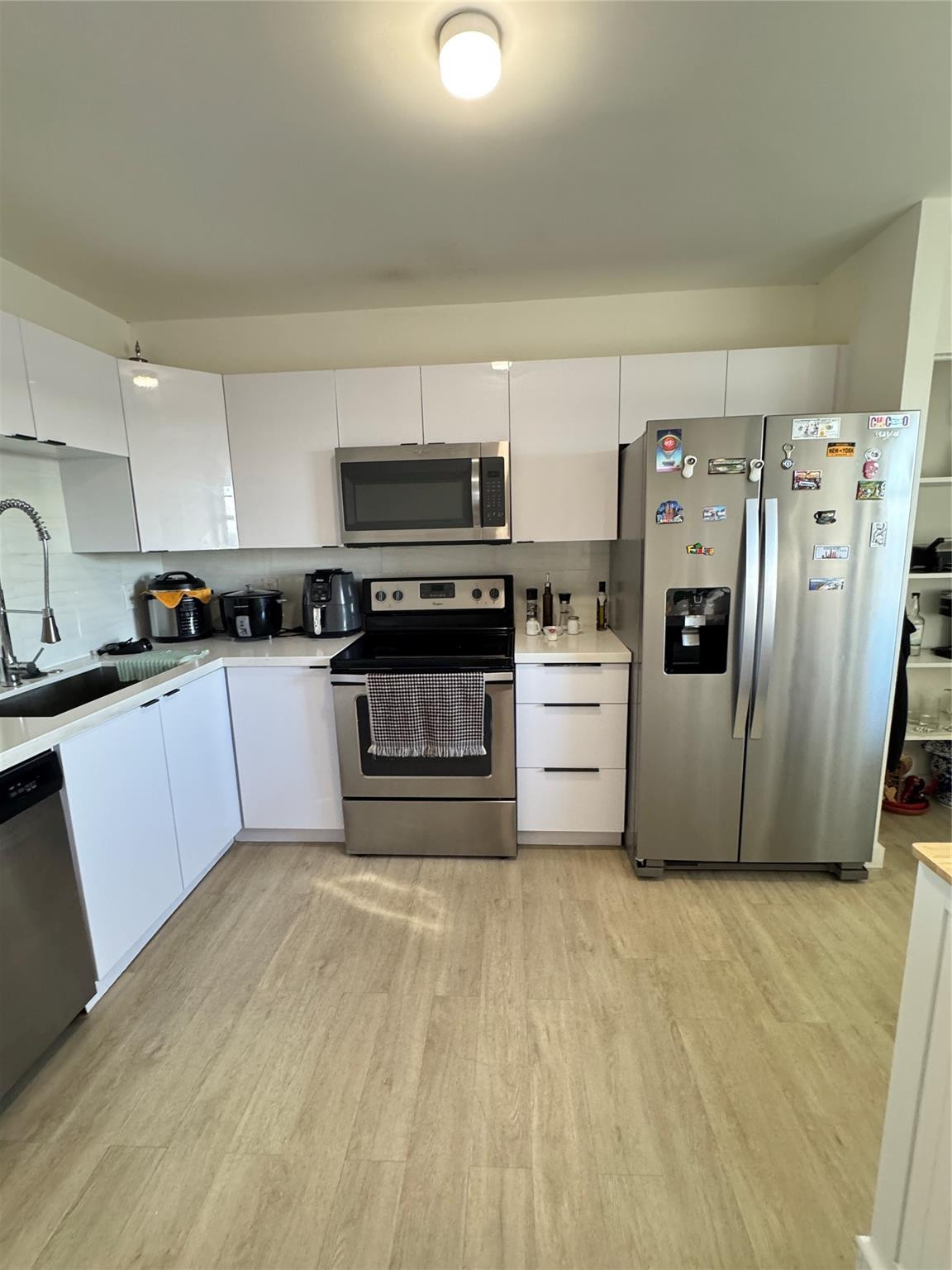 1770 Northeast 191st Street, Unit 816 Miami, FL 33179 - Photo 2 of 33 a kitchen with stainless steel appliances granite countertop a refrigerator a stove top oven a sink and dishwasher