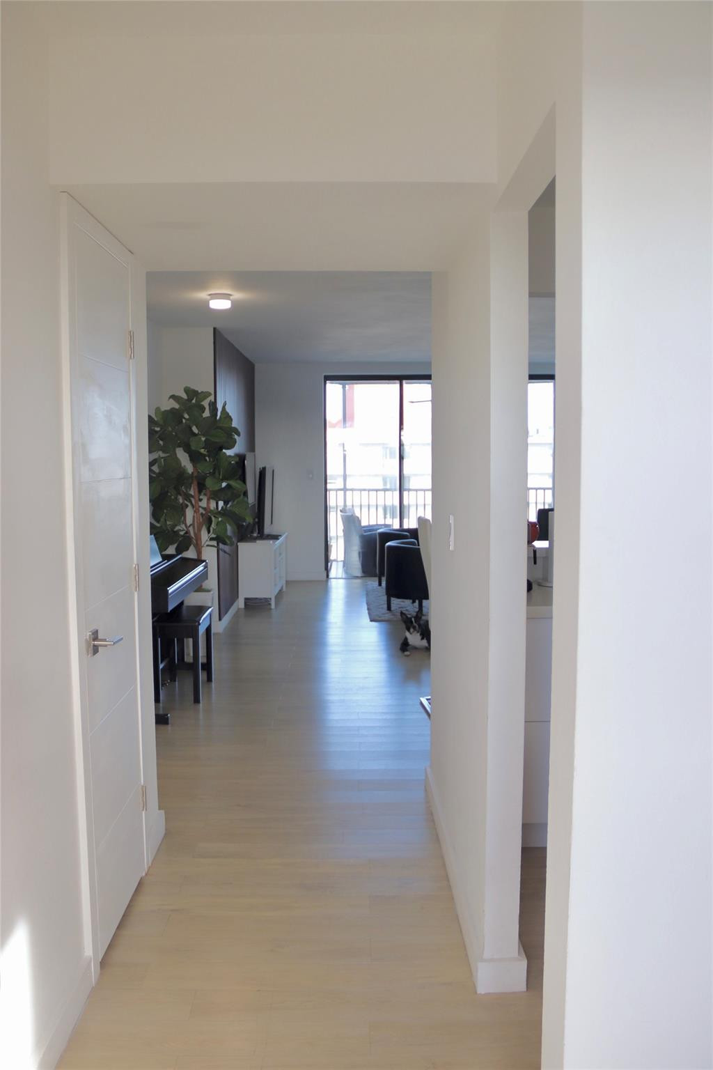 1770 Northeast 191st Street, Unit 816 Miami, FL 33179 - Photo 29 of 33 a hallway with wooden floor and furniture