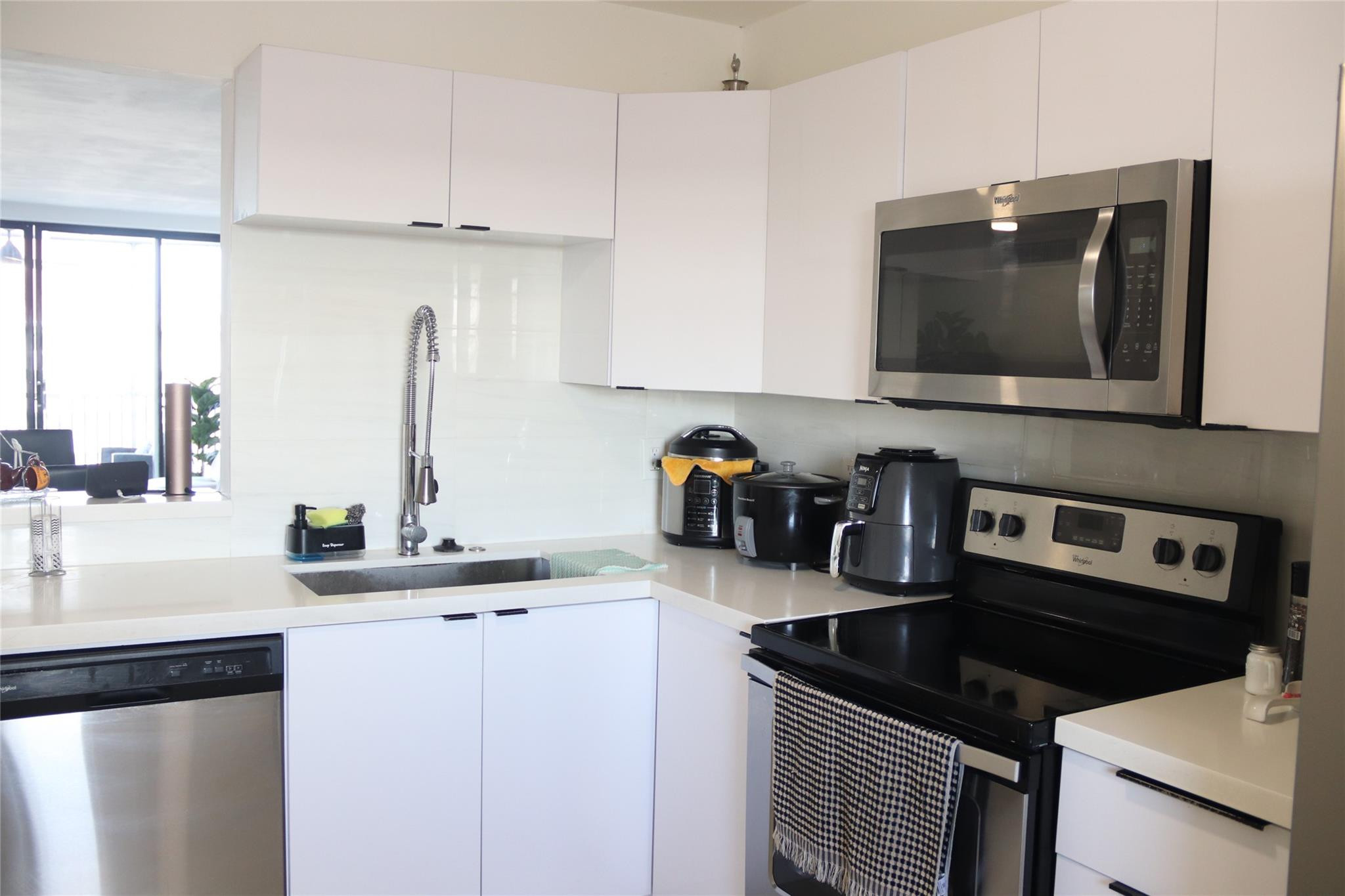 1770 Northeast 191st Street, Unit 816 Miami, FL 33179 - Photo 4 of 33 a kitchen with a sink and cabinets