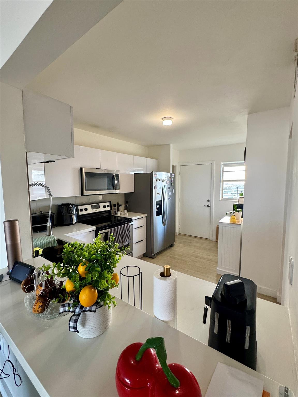 1770 Northeast 191st Street, Unit 816 Miami, FL 33179 - Photo 5 of 33 a kitchen with stainless steel appliances a sink and cabinets