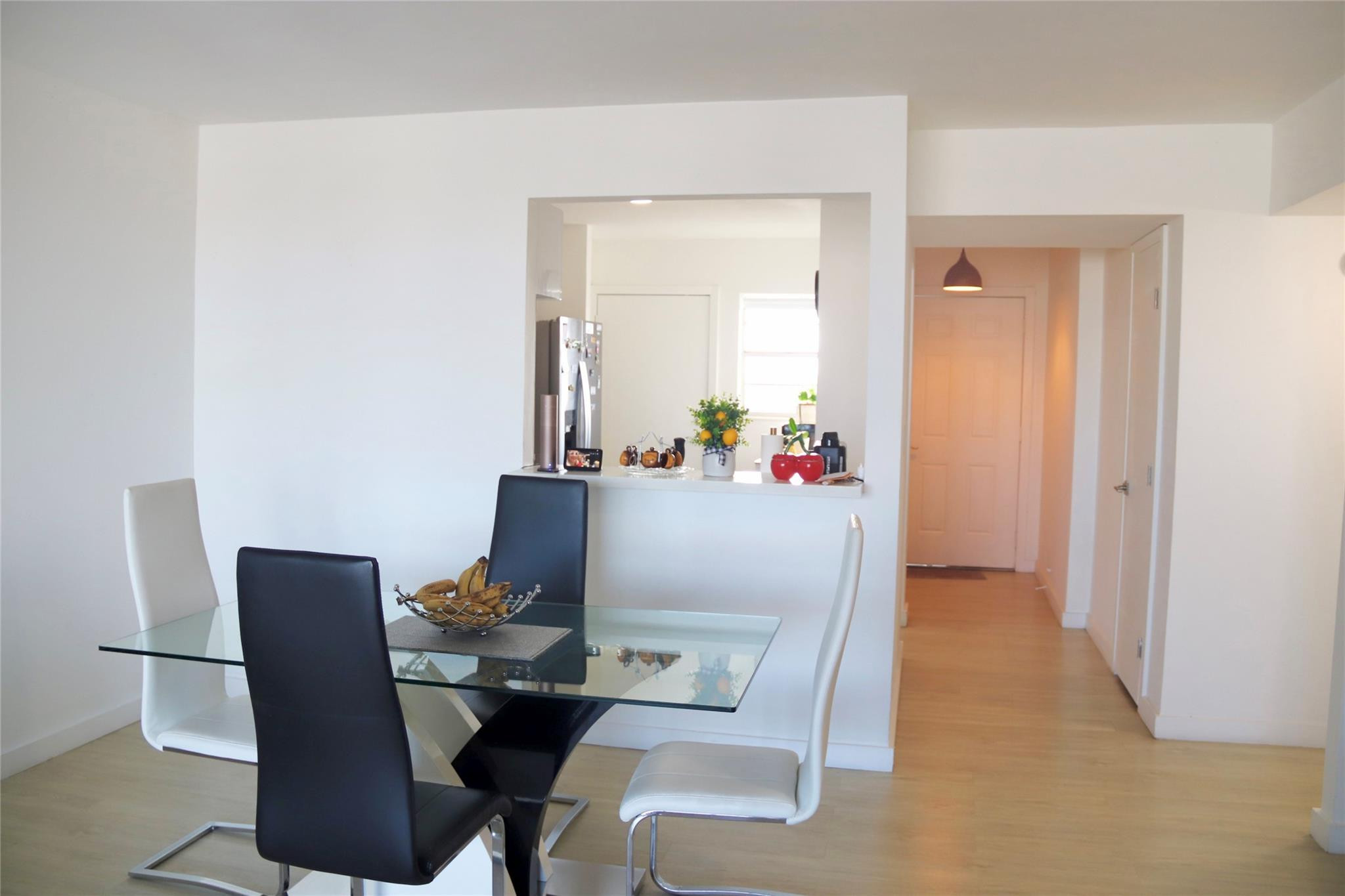 1770 Northeast 191st Street, Unit 816 Miami, FL 33179 - Photo 7 of 33 a dining room with furniture and wooden floor