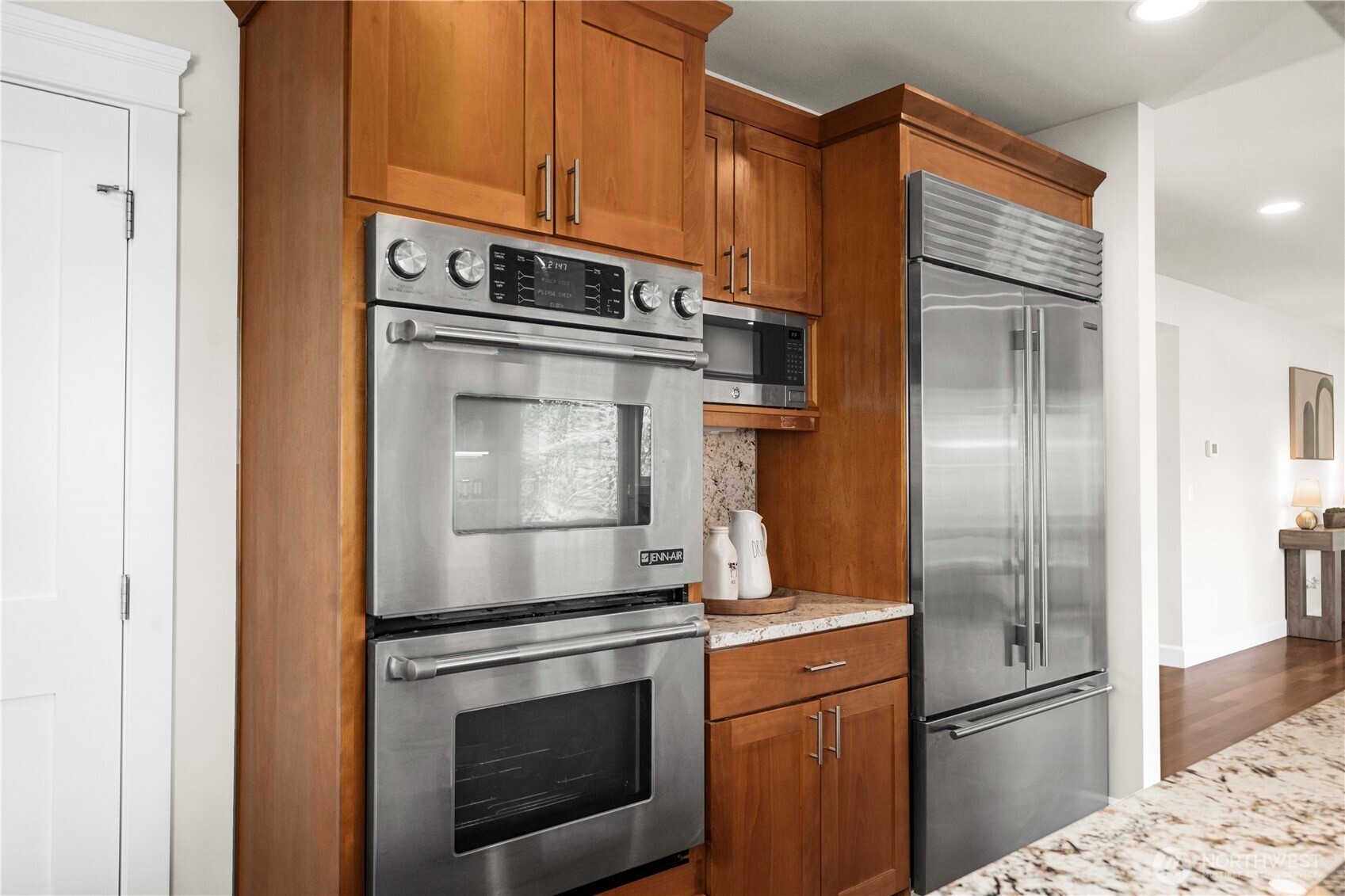 11028 East Riverside Drive Bothell, WA 98011 - Photo 12 of 40 a kitchen with stainless steel appliances granite countertop a refrigerator stove and cabinets