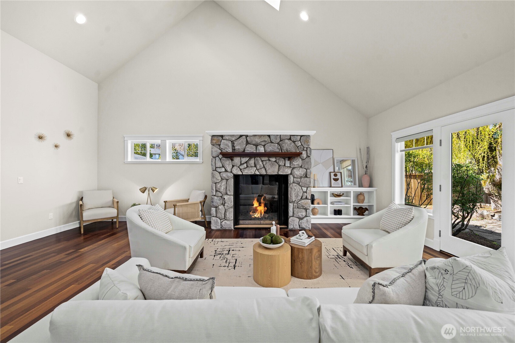 11028 East Riverside Drive Bothell, WA 98011 - Photo 14 of 40 a living room with furniture a fireplace and a large window
