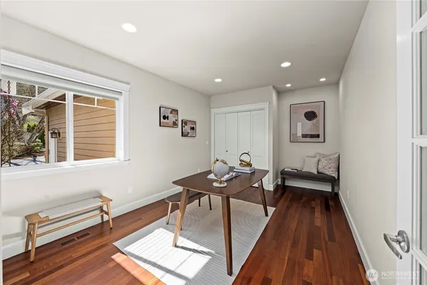 a hallway with chairs and wooden floor