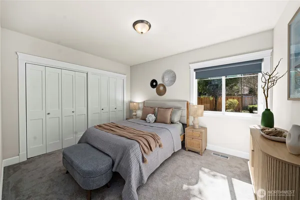 a bedroom with a bed and glass window