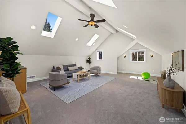 a living room with furniture and potted plant