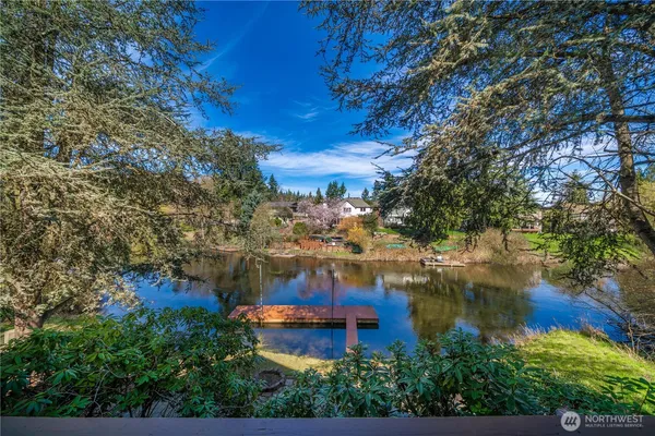 a view of a lake with a house in the background