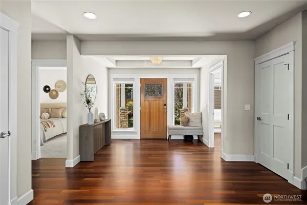 a view of a living room with furniture and wooden floor