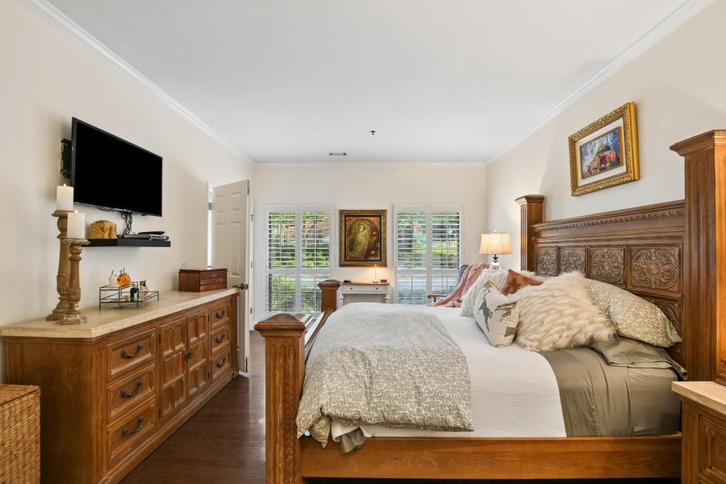 2921 Lenox Road Northeast, Unit 103 Atlanta, GA 30324 - Photo 19 of 37 a bedroom with a bed and a flat screen tv