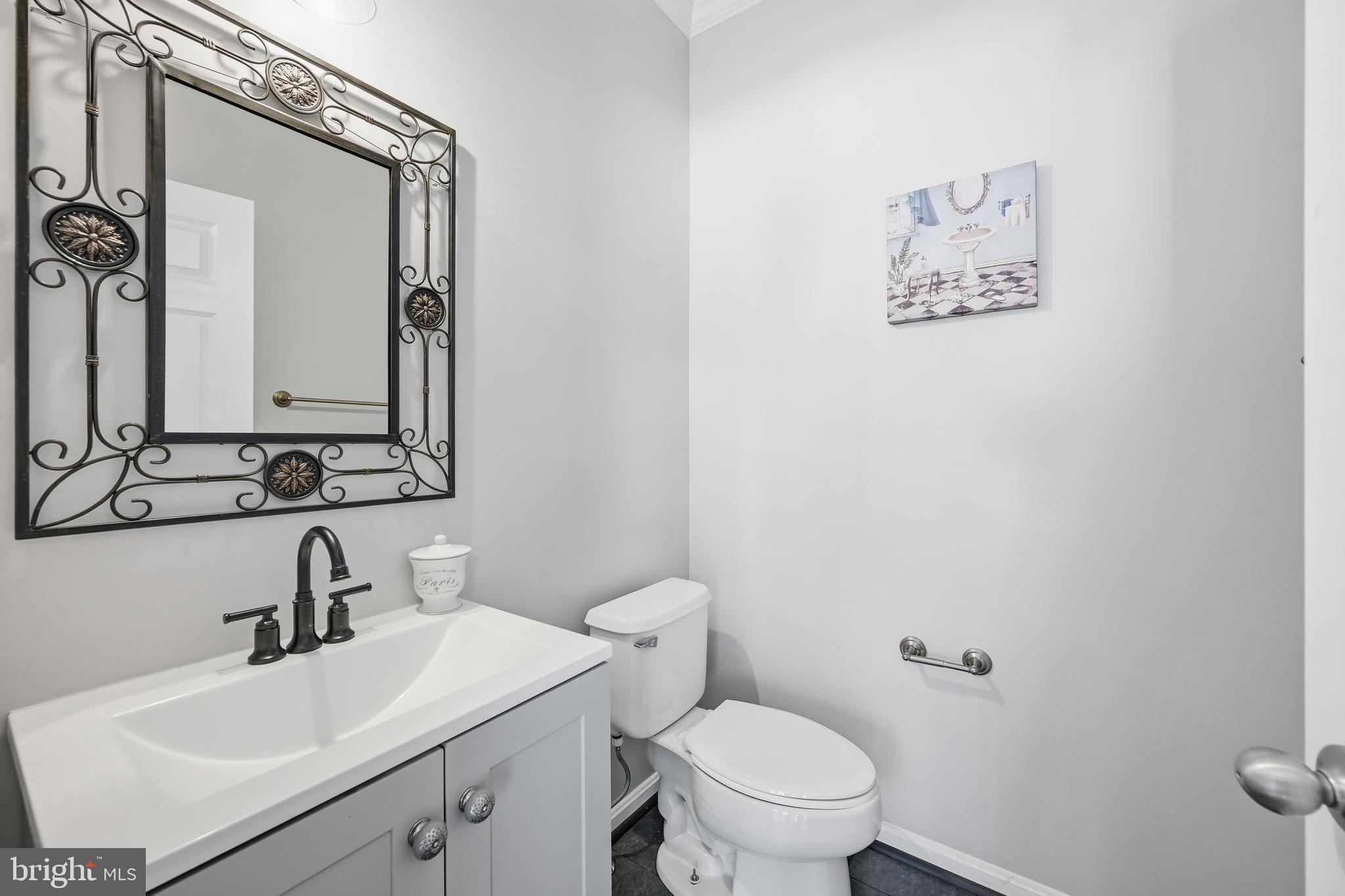 18733 Falling River Drive Gaithersburg, MD 20879 - Photo 11 of 34 a bathroom with a toilet sink and mirror