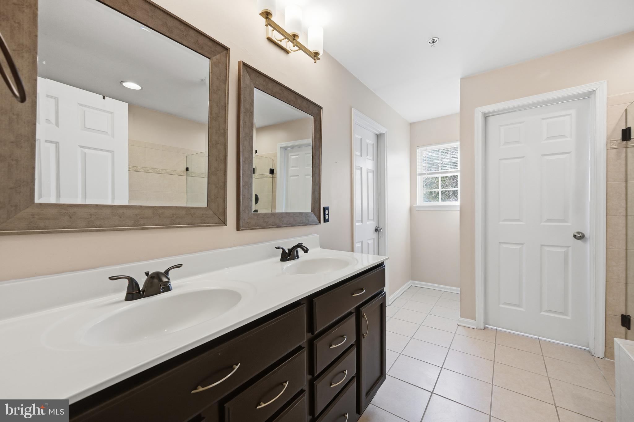 18733 Falling River Drive Gaithersburg, MD 20879 - Photo 18 of 34 a bathroom with a sink double vanity and a mirror