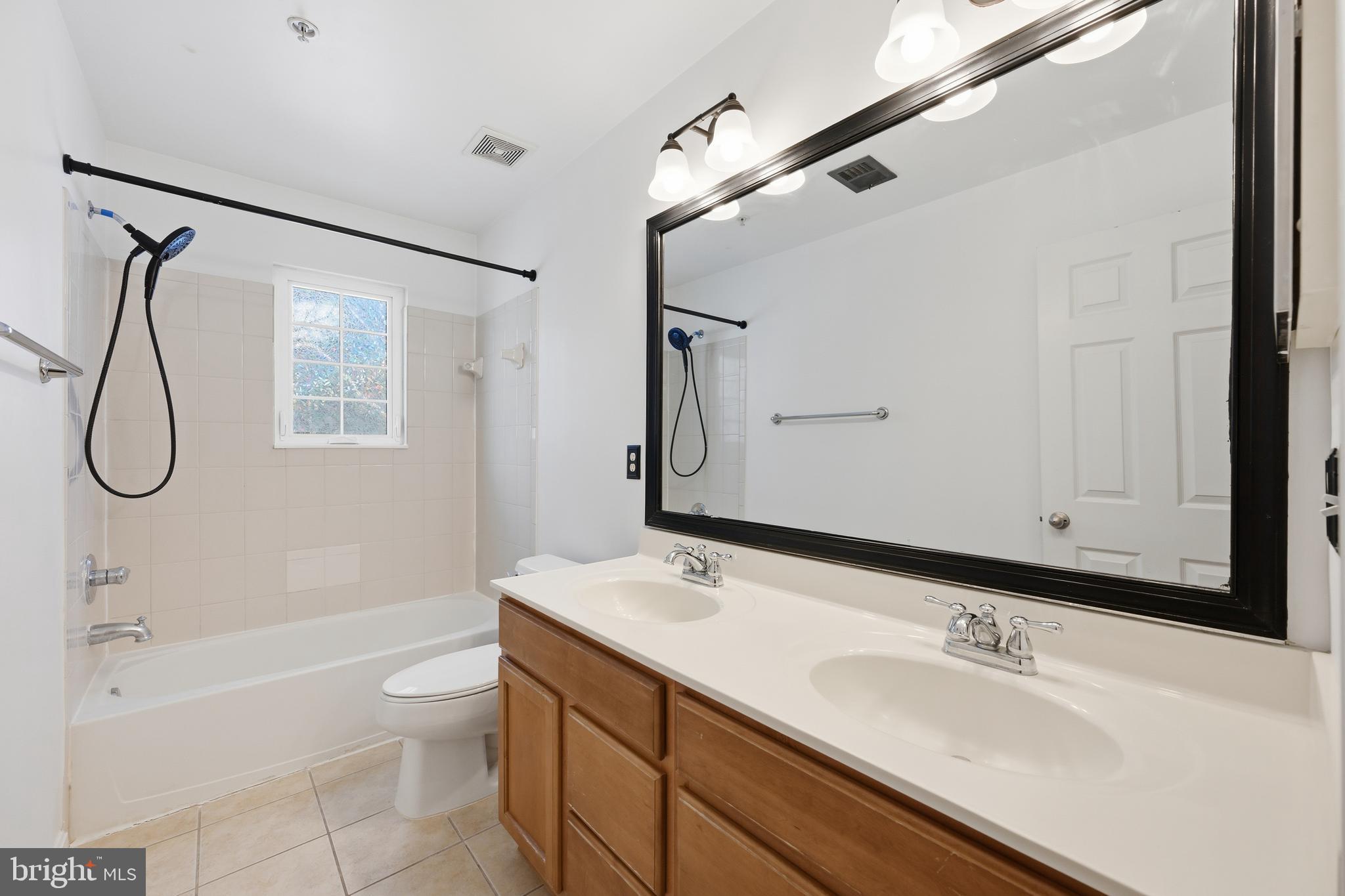 18733 Falling River Drive Gaithersburg, MD 20879 - Photo 23 of 34 a bathroom with a granite countertop sink a toilet and shower