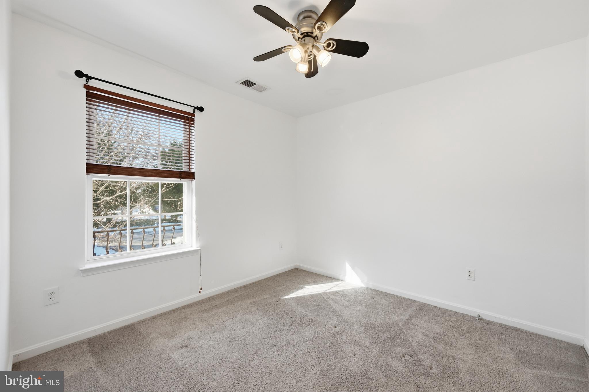 18733 Falling River Drive Gaithersburg, MD 20879 - Photo 25 of 34 an empty room with a window and a fan