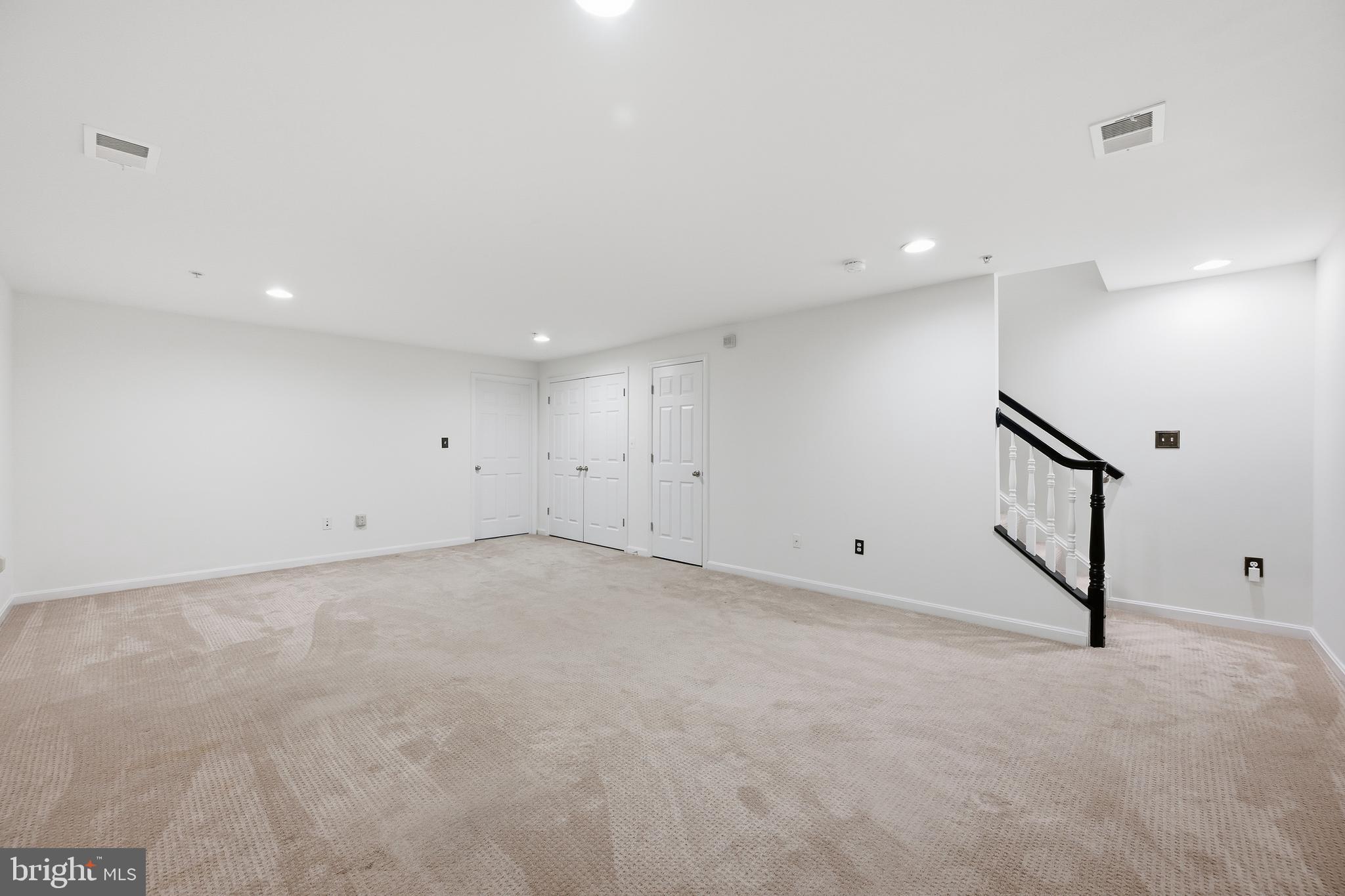 18733 Falling River Drive Gaithersburg, MD 20879 - Photo 29 of 34 an empty room with white walls and stairs