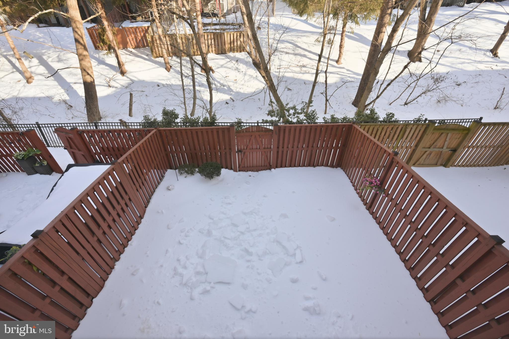 18733 Falling River Drive Gaithersburg, MD 20879 - Photo 32 of 34 a view of backyard with wooden fence and large trees