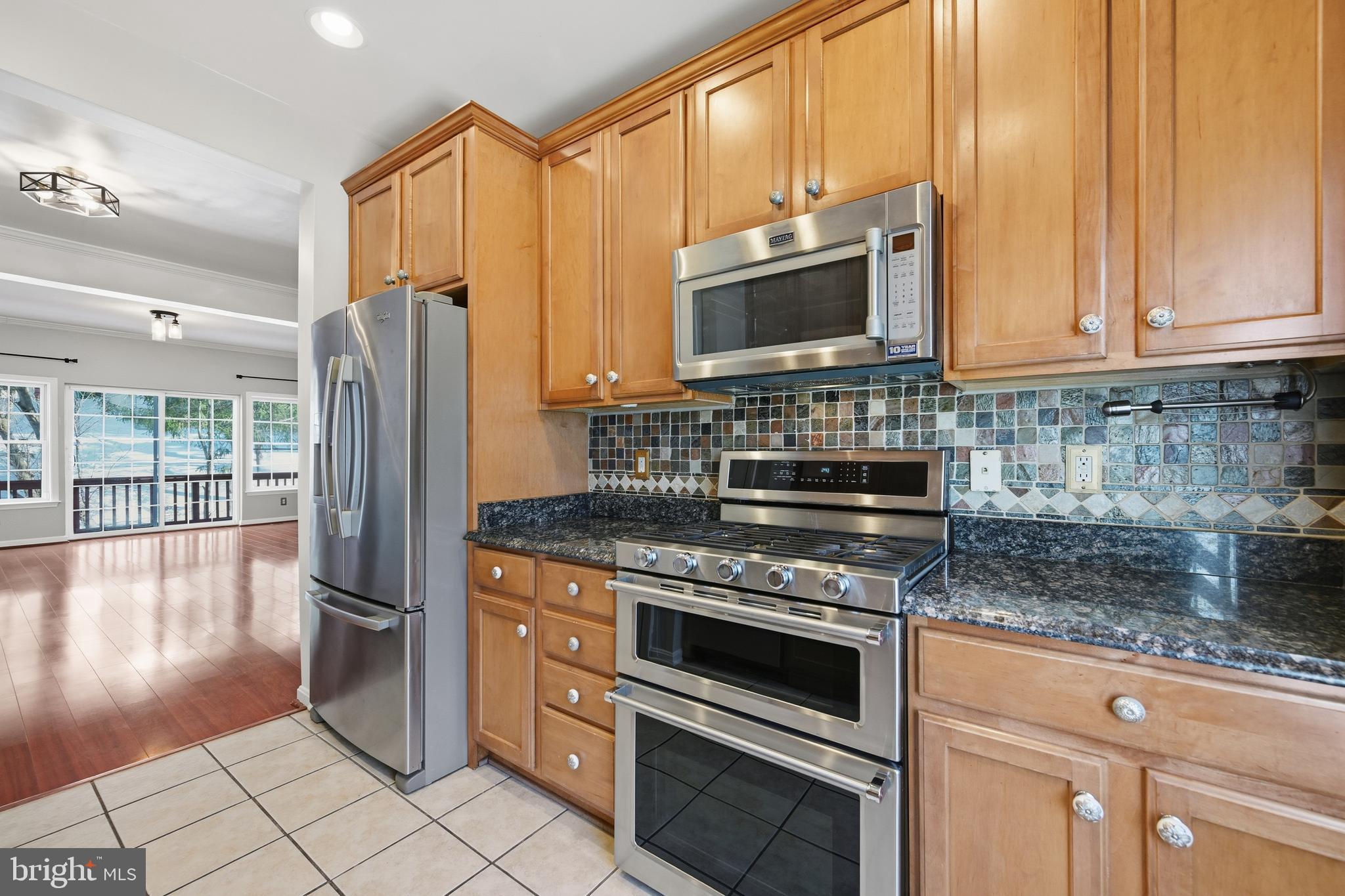 18733 Falling River Drive Gaithersburg, MD 20879 - Photo 5 of 34 a kitchen with stainless steel appliances granite countertop a stove a refrigerator and a microwave