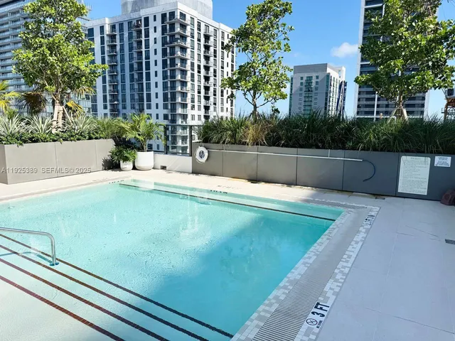 a swimming pool with outdoor seating and yard