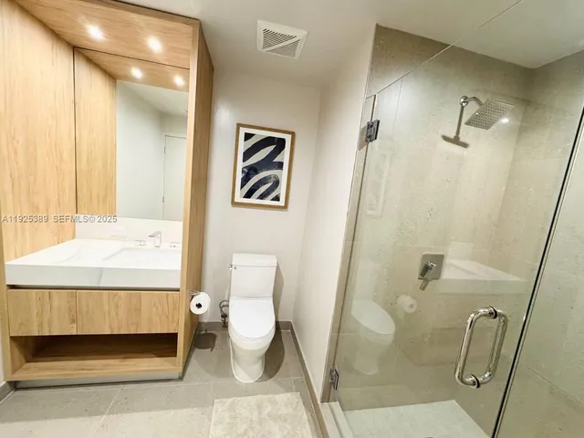 a bathroom with a toilet and a shower