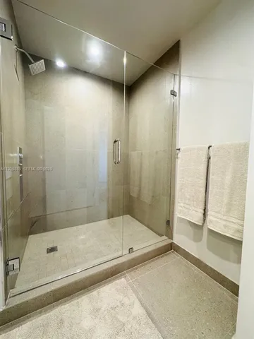 a bathroom with a shower and a bath tub