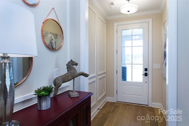 a view of dining room with wooden floor and a potted plant
