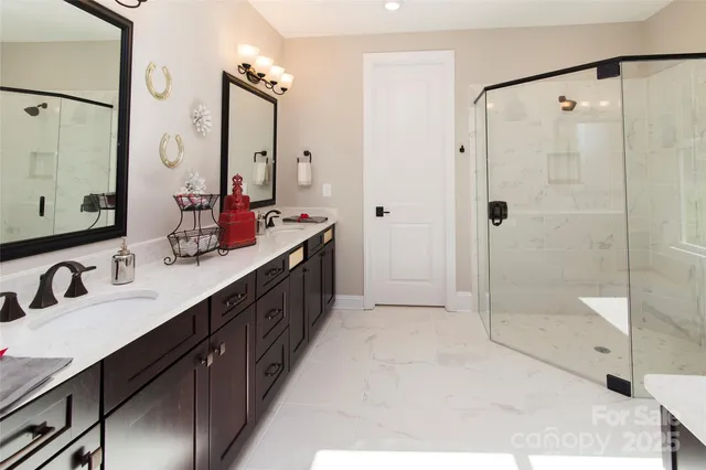 a bathroom with a double vanity sink mirror double and shower