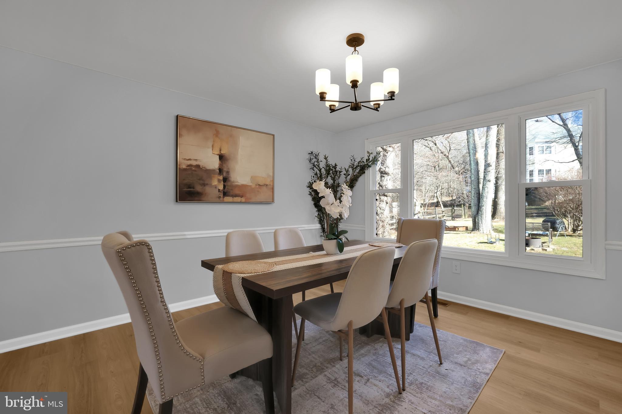 15101 Snowden Drive Silver Spring, MD 20905 - Photo 11 of 68 a view of a dining room with furniture wooden floor and chandelier