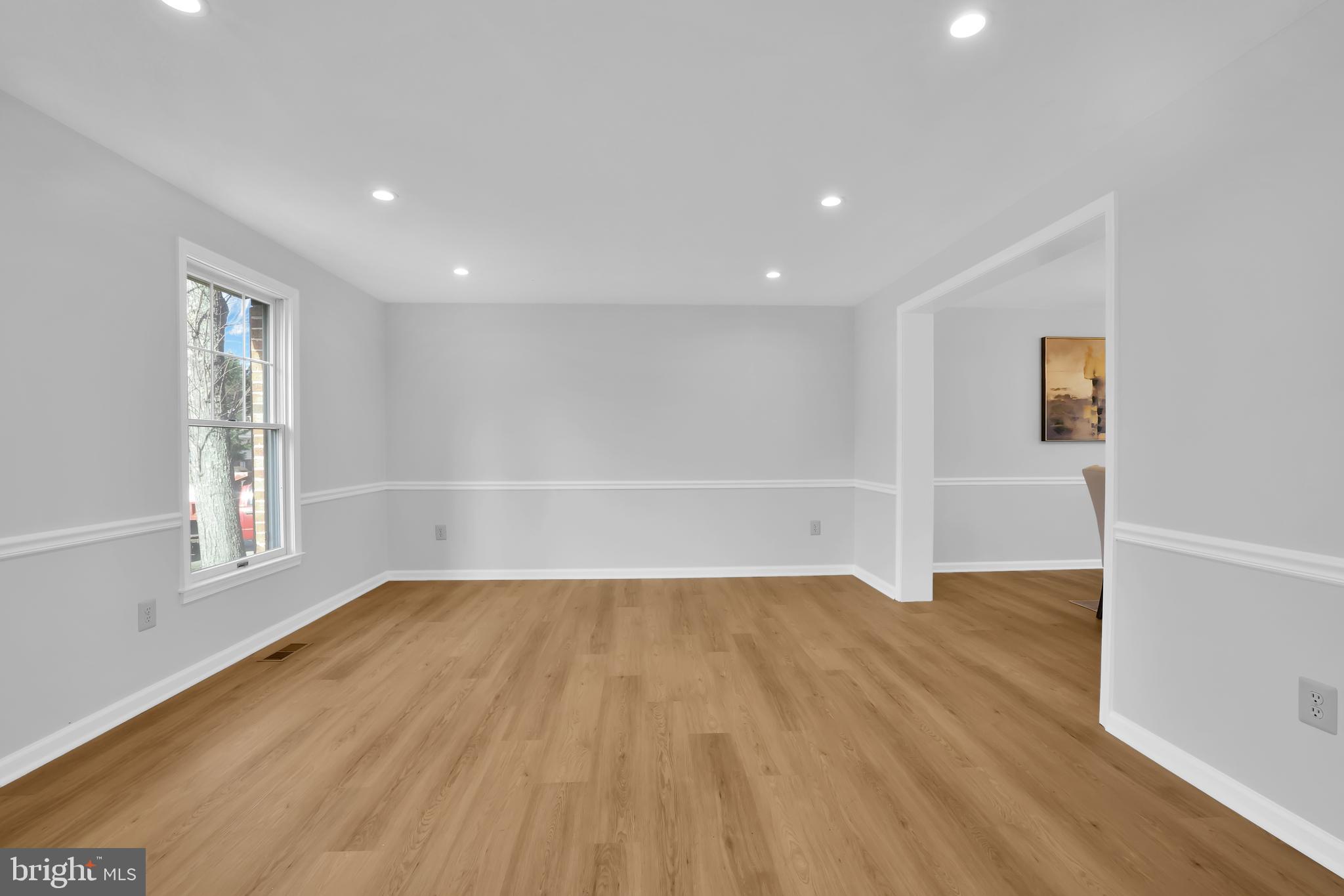 15101 Snowden Drive Silver Spring, MD 20905 - Photo 17 of 68 a view of an empty room with wooden floor and a window