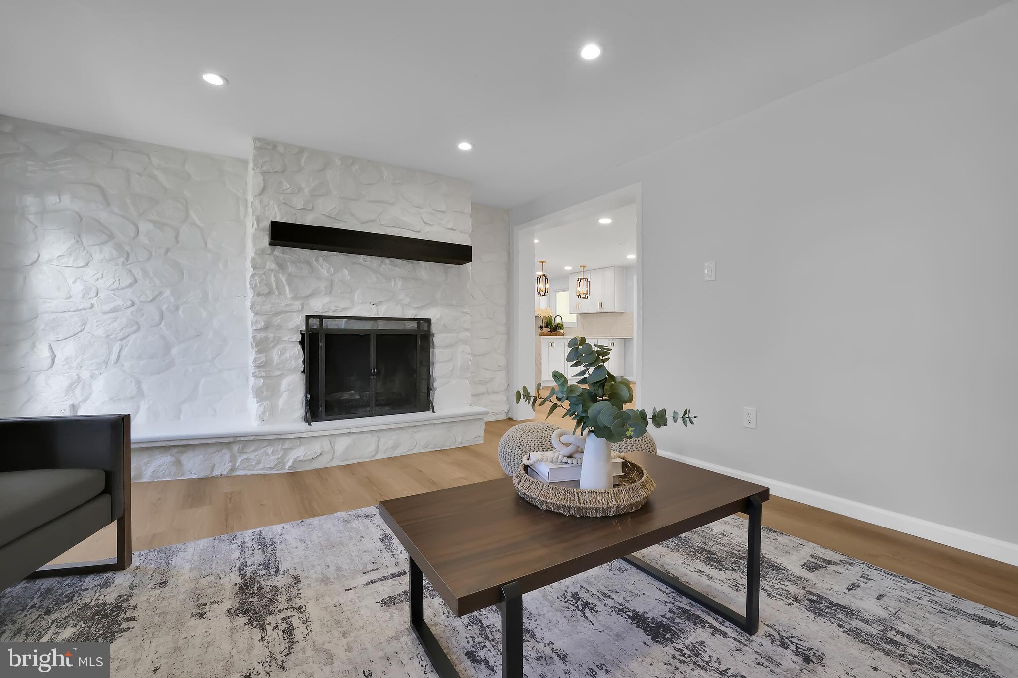 15101 Snowden Drive Silver Spring, MD 20905 - Photo 22 of 68 a living room with furniture and a fireplace