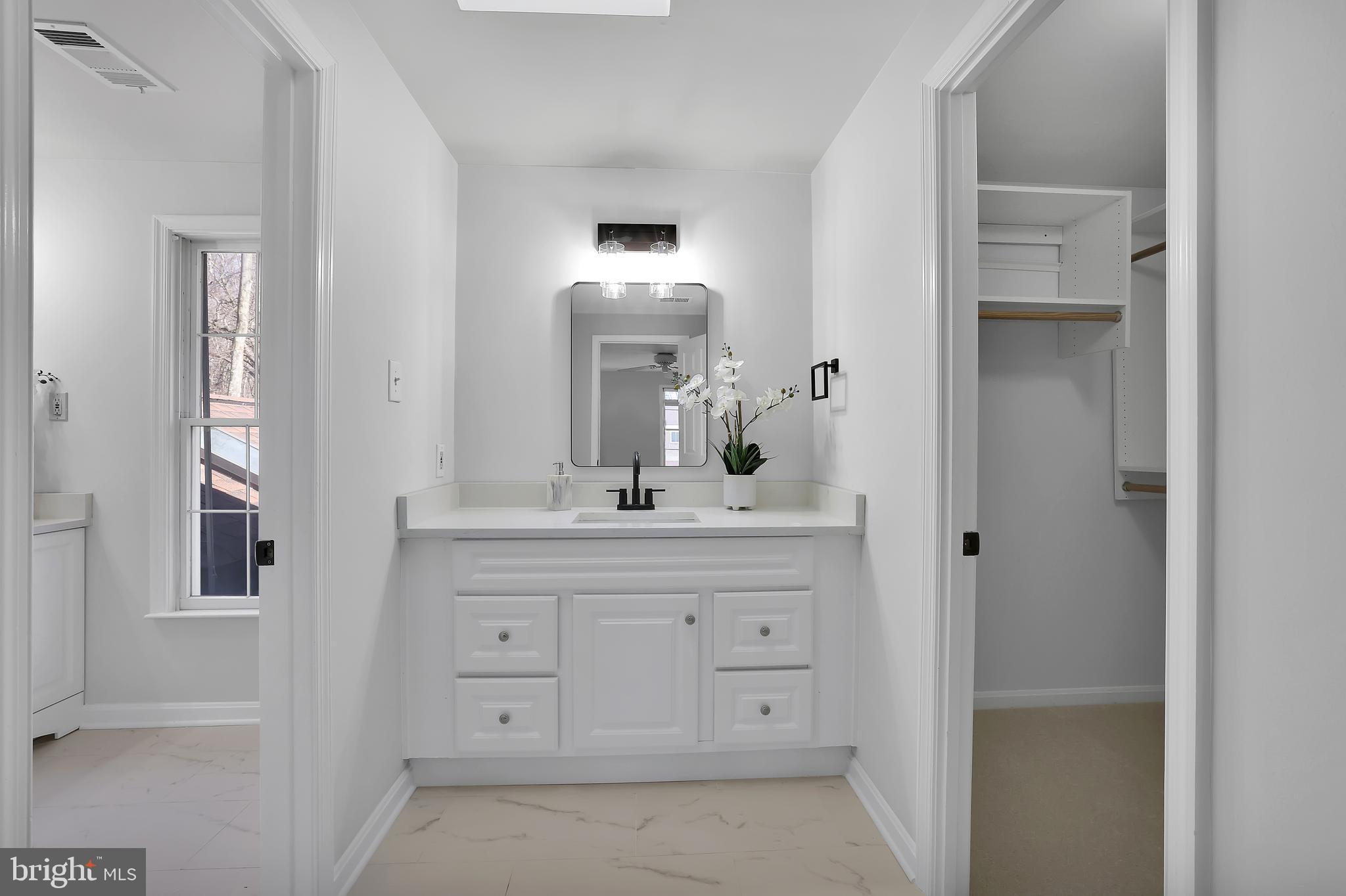 15101 Snowden Drive Silver Spring, MD 20905 - Photo 41 of 68 a bathroom with a double vanity sink and a mirror